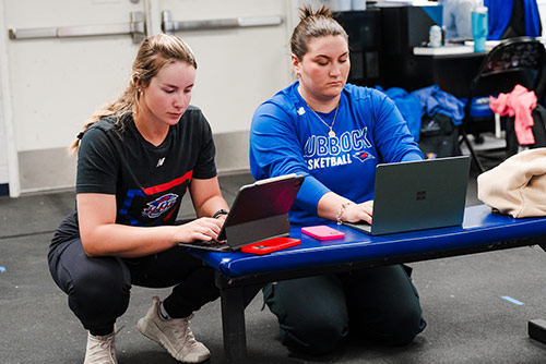 Two students working on laptops